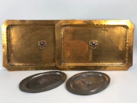 Local interest: Metalware to include a pair of copper trays each with applied central coat of