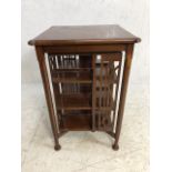 Large table/canterbury on octagonal legs with rotating book shelf to centre, approx 60cm x 60cm x