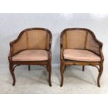 A pair of bergere style armchairs with chinese bamboo styling and leather seat pads