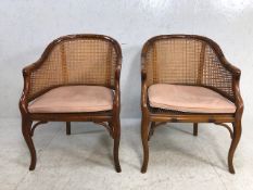 A pair of bergere style armchairs with chinese bamboo styling and leather seat pads