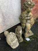 Three concrete garden ornaments to include a pixie and a dog