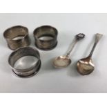 Collection of silver items to include Three Hallmarked silver napkin rings and two silver spoons (