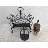 Decorative Iron work magazine rack with an iron work bottle holder, copper kettle and arts and