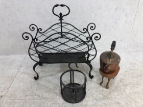 Decorative Iron work magazine rack with an iron work bottle holder, copper kettle and arts and