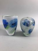 studio art glass, two twin layered vases of blue flowers on an opaque white background both with