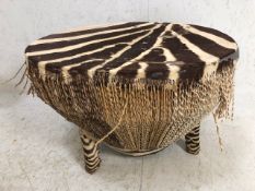 Zebra hide large African drum on three legs, approx 71cm in diameter