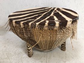 Zebra hide large African drum on three legs, approx 71cm in diameter