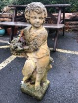 Garden statue of a boy with a basket of fruit