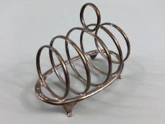 Hallmarked silver toast rack with graduated circular dividers on oval base with four splayed feet