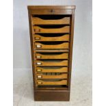 Dark stained roll front collectors or music cabinet, run of 9 internal drawers with scallop fronts