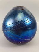 Studio art glass, hand blown iridescent blue ball vase with raised swirl decoration signed Siddy