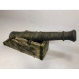 Military interest ,19th century cast Iron cannon barrel on wooden stand approximately 79cm in