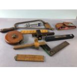 Vintage tools, to include wood markers, set square, surveyors tape, level, wooden folding rules, and