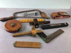 Vintage tools, to include wood markers, set square, surveyors tape, level, wooden folding rules, and