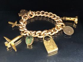 15ct Gold curb link chunky bracelet with 15ct Gold heart shaped lock, and Gold charms to include a