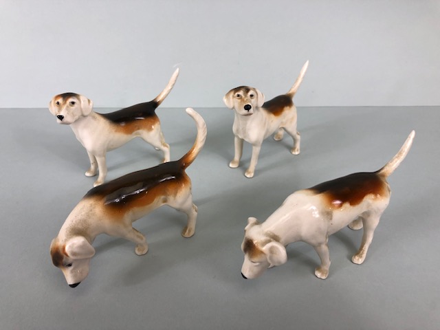 Beswick China, four black stamp fox hounds the undersides stamped Beswick England (approximately 7cm