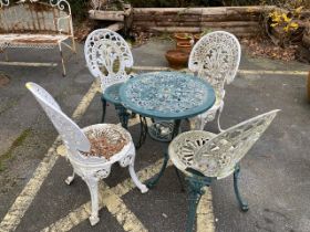 Metal bistro table with four chairs