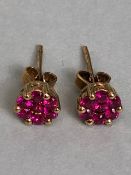 Pair of 9ct Gold earrings set with red gemstones in a six claw setting