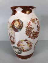 Antique Japanese satsuma vase decorated with roundels of flowers and geometric designs and a central