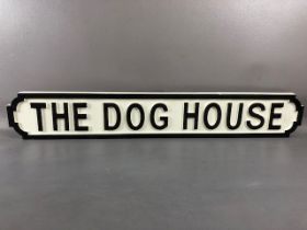 Modern wooden sign, 'THE DOG HOUSE', in the form of a cast iron road sign, approx 87cm in length