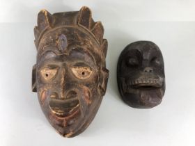 Tribal art, Two Carved wooden African Masks possibly Chokwe, the larger approximately 37cm the