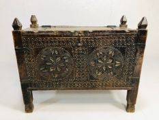 Antique furniture, 19th century north Indian dowry chest on legs, the front deeply carved with
