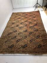 Antique Rug, large hand knotted Bokhara wool rug, geometric designs on a faded red background