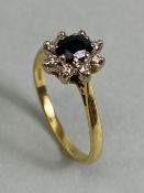 18ct Gold Sapphire and Diamond Daisy ring the faceted oval Sapphire approx 5.6mm x 4.2mm and ring