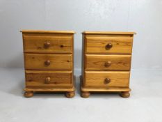 Pine furniture, 2 bedside chest of drawers, each with a run of 3 drawers on bun feet, both