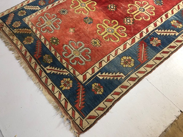 Oriental Rug, Konya wool rug with typical geometric patterns on red back ground with blue border - Image 2 of 7