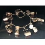 Silver 925 charm bracelet of elongated bar links with heart clasp and 12 charms to include a