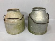 Two Continental milk churns of patinated alloy with steel handles each approximately 36cm high