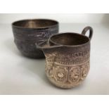 Victorian Hallmarked silver sugar bowl and milk jug each depicting the signs of the Zodiac, the bowl