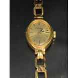 9ct Gold watch with gold coloured dial and baton numerals on a 9ct gold strap (total weight approx