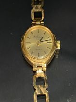 9ct Gold watch with gold coloured dial and baton numerals on a 9ct gold strap (total weight approx