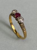 18ct Gold three stone ring set with a central Ruby and flanked by two diamonds approx size 'L' and