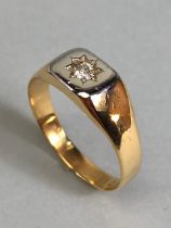 18ct Gold signet ring set with a single diamond in a star shaped setting size approx 'U' and total