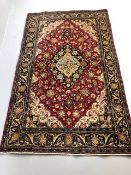 Oriental Rug, Wool rug of Persian design predominantly red background with typical arabesque