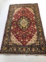 Oriental Rug, Wool rug of Persian design predominantly red background with typical arabesque