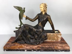 Art Deco Mantel figure of a reclined woman with faux ivory head and hands in a silver decorated