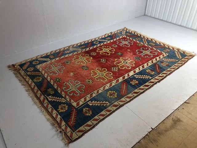 Oriental Rug, Konya wool rug with typical geometric patterns on red back ground with blue border