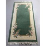 Modern Chinese style sculpted wool rug in green and cream with flower decoration approximately 185 x