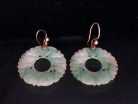Pair of circular Jade earrings each approx 24mm in diameter and on gold coloured wire possibly