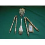 Pair of early plated nutcrackers together with a decorative plated berry spoon
