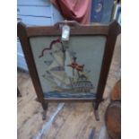 Oak framed fire screen inset needlework panel of a sailing ship