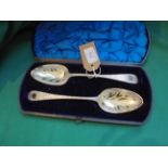 Boxed pair of ornately engraved serving spoons each with gilded bowl (London 1829 and London 1834)