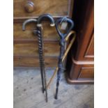 2 heavily carved ebony walking sticks and 2 others