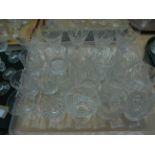 2 trays of white cut glass drinking vessels incl.