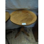 Circular topped light oak drinks table on tricorn base