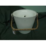 White ground lidded slop bucket with rafia handle